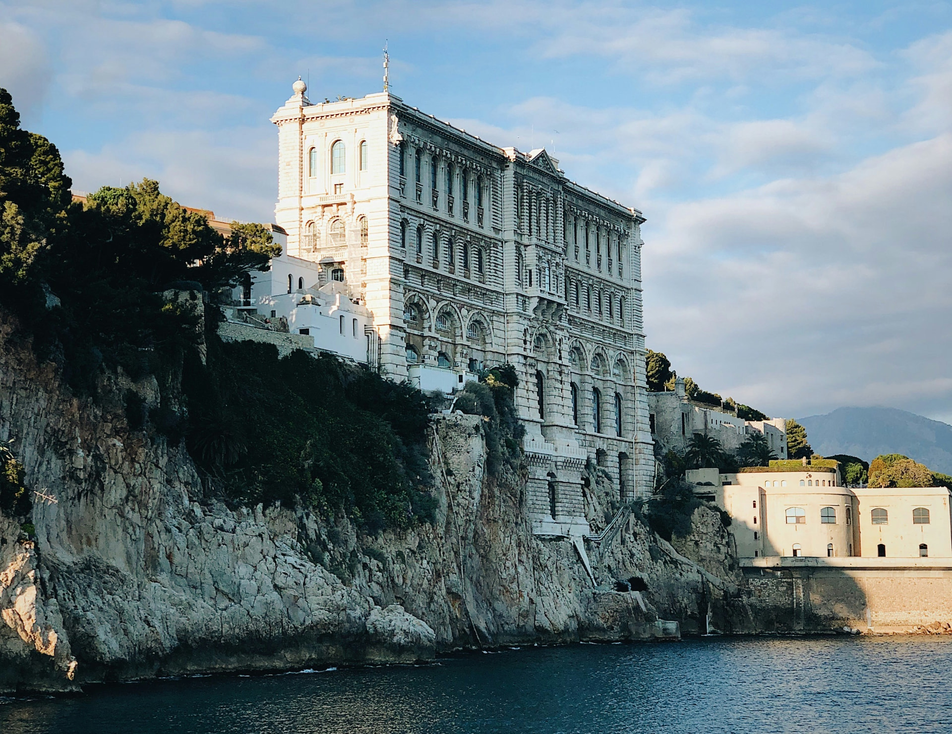 The Oceanographic Museum of Monaco, a classical stone building perched on a cliff above the deep blue Mediterranean